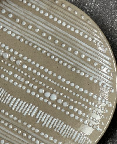 What is Stoneware? Stoneware is a broad term for pottery fired at a relatively high temperature.A modern definition is a vitreous or semi-vitreous ceramic made primarily from stoneware clay or non-refractory fire clay.[3][4] End applications include tableware, decorative ware such as vases. Stoneware is fired at between about 1,100 °C (2,010 °F) to 1,300 °C (2,370 °F). Historically, reaching such temperatures was a long-lasting challenge, and temperatures somewhat below these were used for a long time. Three contemporary stoneware mixing bowls It was developed independently in different locations around the world, after earthenware and before porcelain. Stoneware is not recognised as a category in traditional East Asian terminology, and much Asian stoneware, such as Chinese Ding ware for example, is counted as porcelain by local definitions.Terms such as "porcellaneous" or "near-porcelain" may be used in such cases. Traditional East Asian thinking classifies pottery only into "low-fired" and "high-fired" wares, equating to earthenware and porcelain, without the intermediate European class of stoneware, and the many local types of stoneware were mostly classed as porcelain, though often not white and translucent. One definition of stoneware is from the Combined Nomenclature of the European Communities, a European industry standard. It states: Stoneware, which, though dense, impermeable and hard enough to resist scratching by a steel point, differs from porcelain because it is more opaque, and normally only partially vitrified. It may be vitreous or semi-vitreous. It is usually coloured grey or brownish because of impurities in the clay used for its manufacture, and is normally glazed​